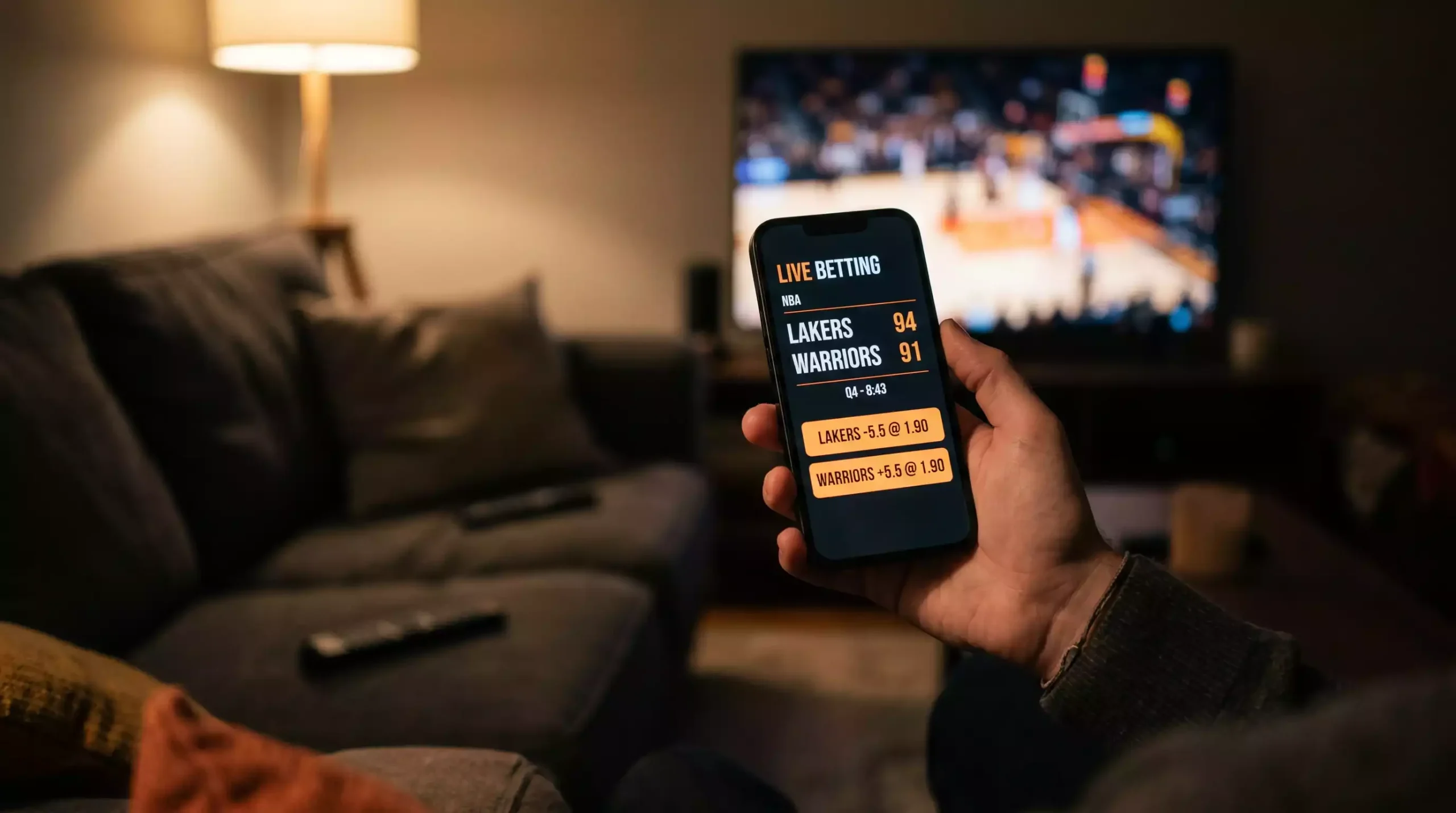 Mobile phone showing live basketball betting odds and in-play markets