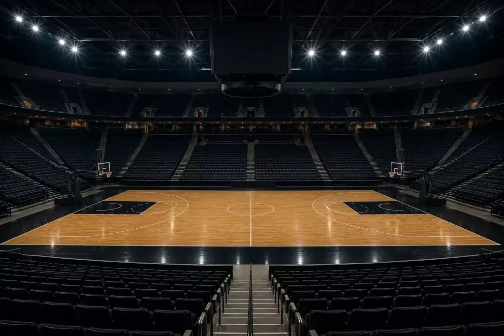 Empty NBA basketball arena with hardwood court viewed from the stands before a game
